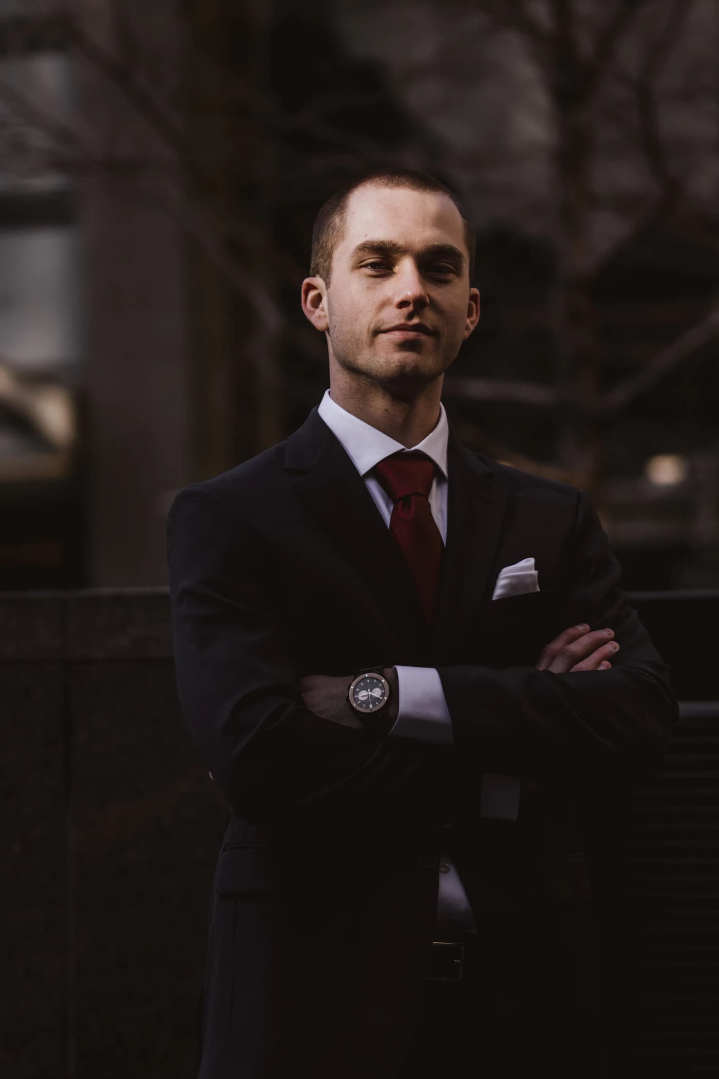 A founder in a tailored suit, composed and considered.